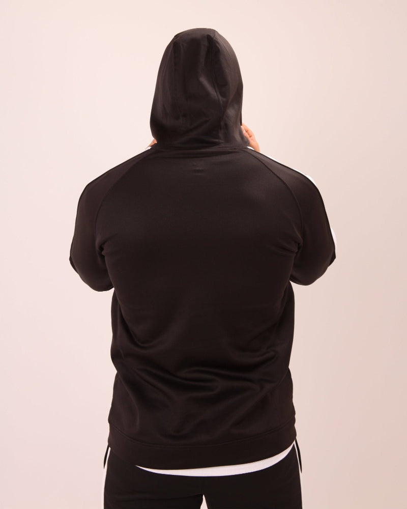 Man wearing a UNIFY U1 black and white zip-up hoodie, ideal for both casual and active outings.