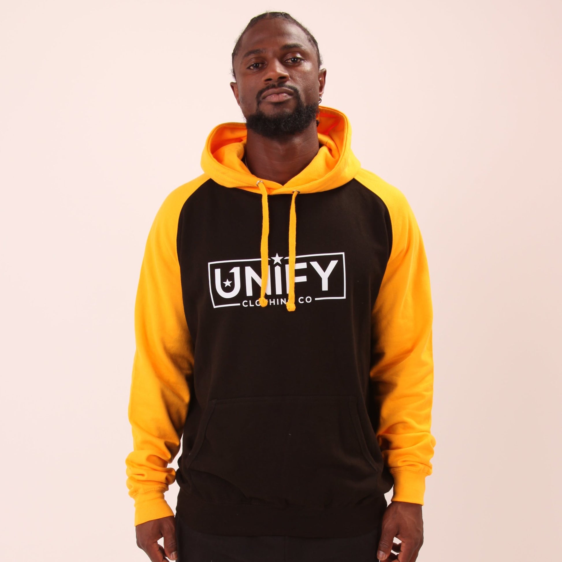 "UNIFY's essential men's hoodie in a striking yellow hue, highlighting its soft material and snug design."