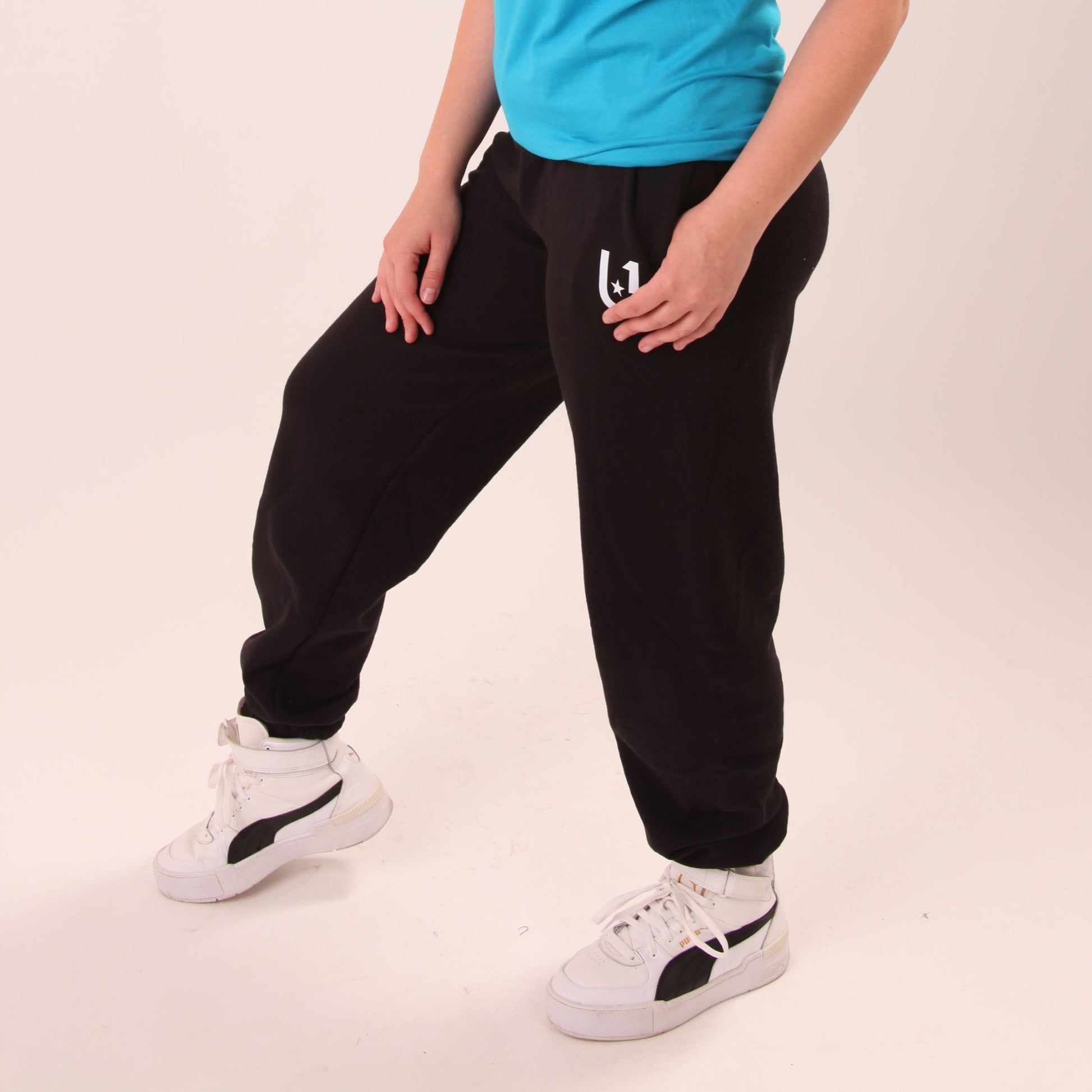 Laid-back luxury with UNIFY women's relaxed black joggers, highlighting comfort and style.