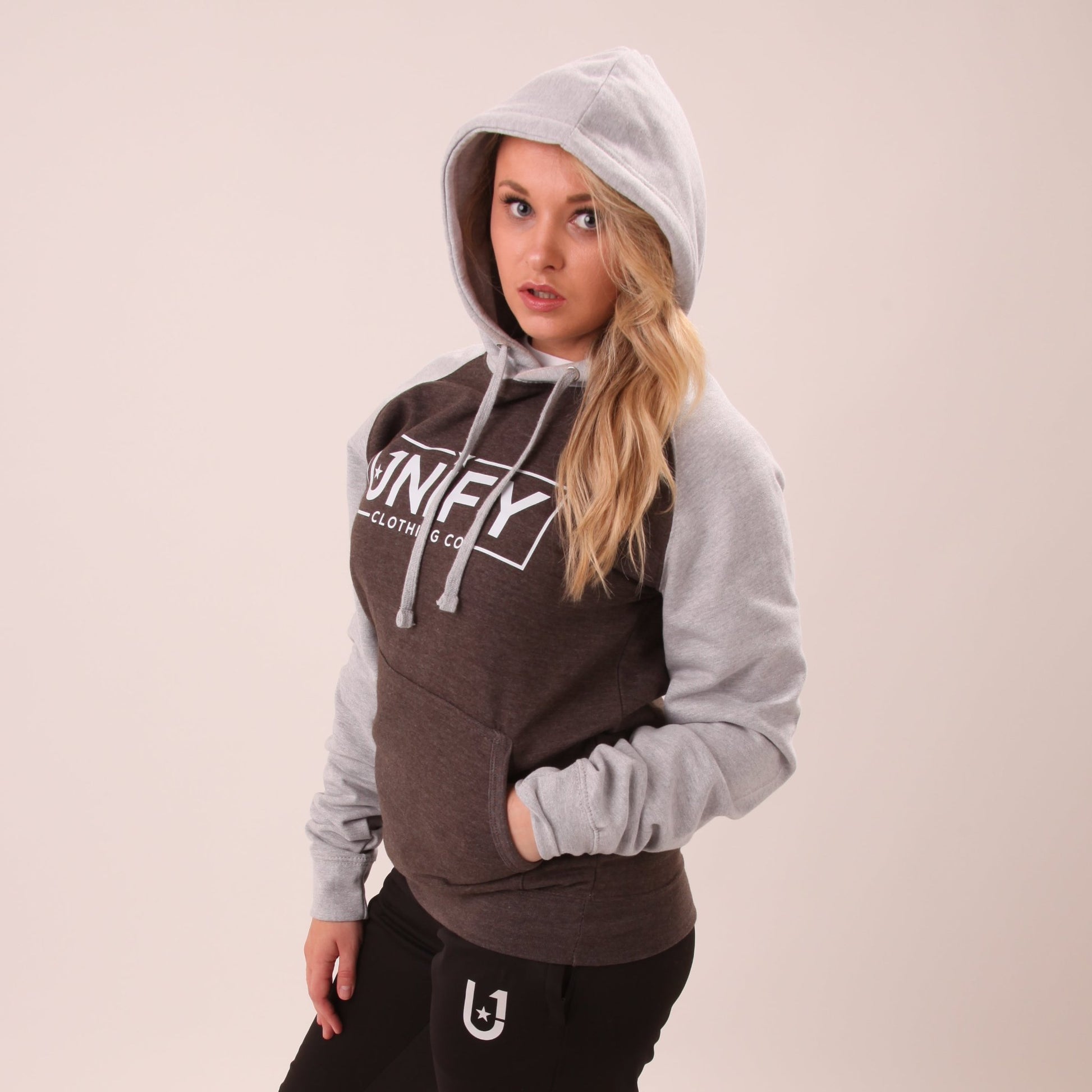 "Close-up view of the UNIFY women's grey hoodie, emphasizing its soft texture and stylish fit."