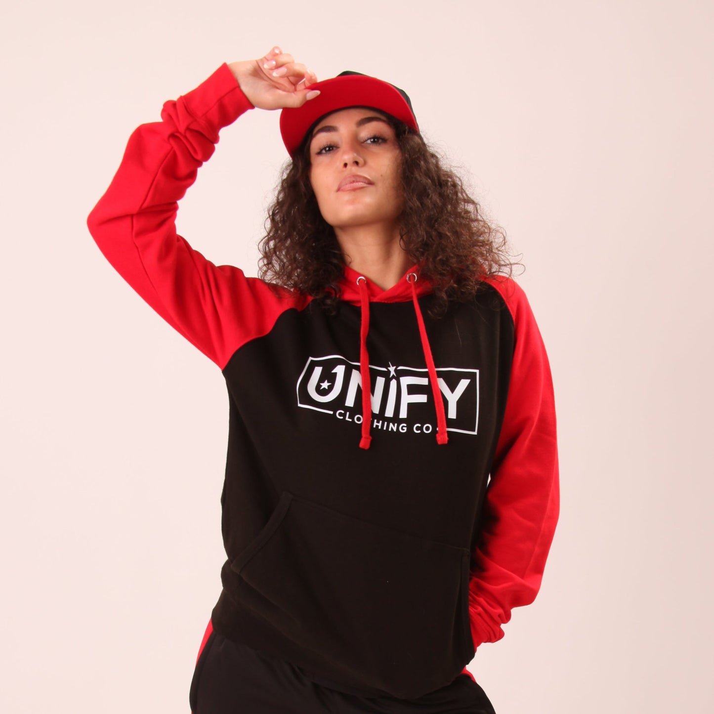 "Woman wearing UNIFY's essential hoodie, showcasing its versatile design suitable for both active and relaxed days."