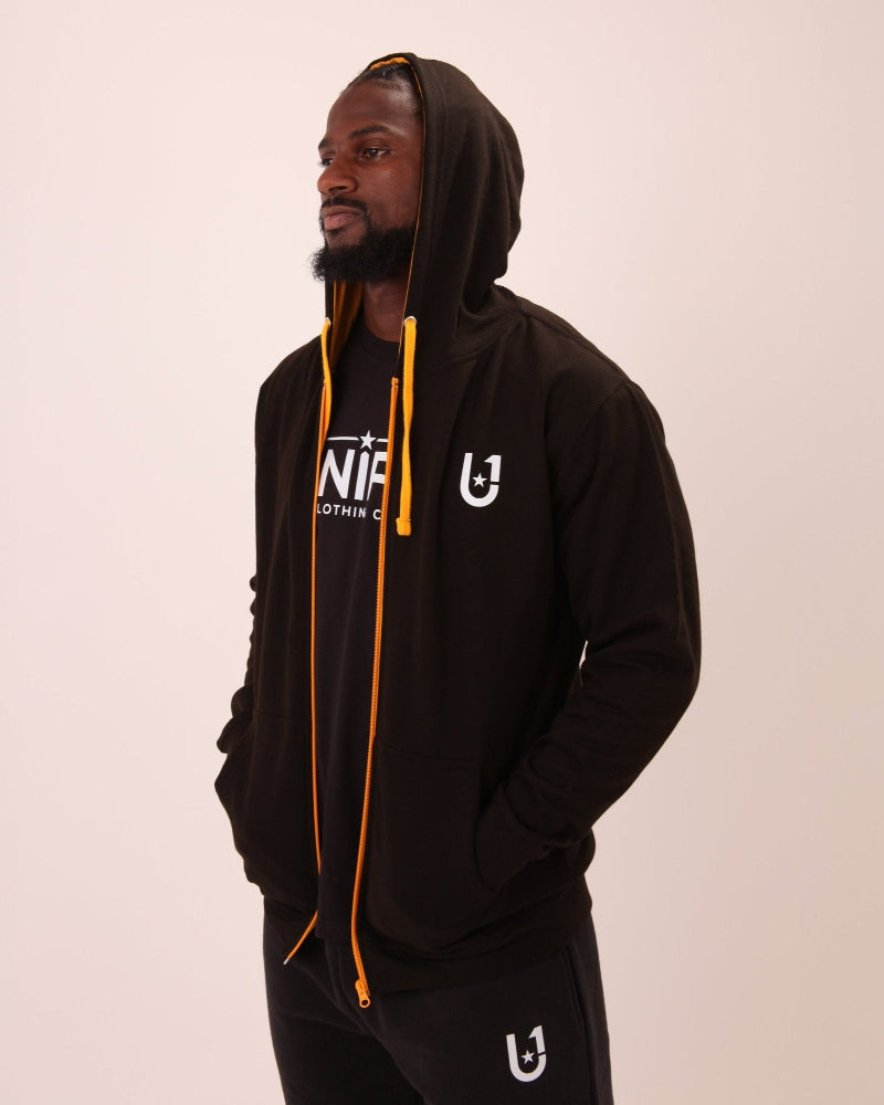 Close-up of UNIFY's men's black hoodie with yellow accents and zipper, highlighting its unique colour scheme and design.