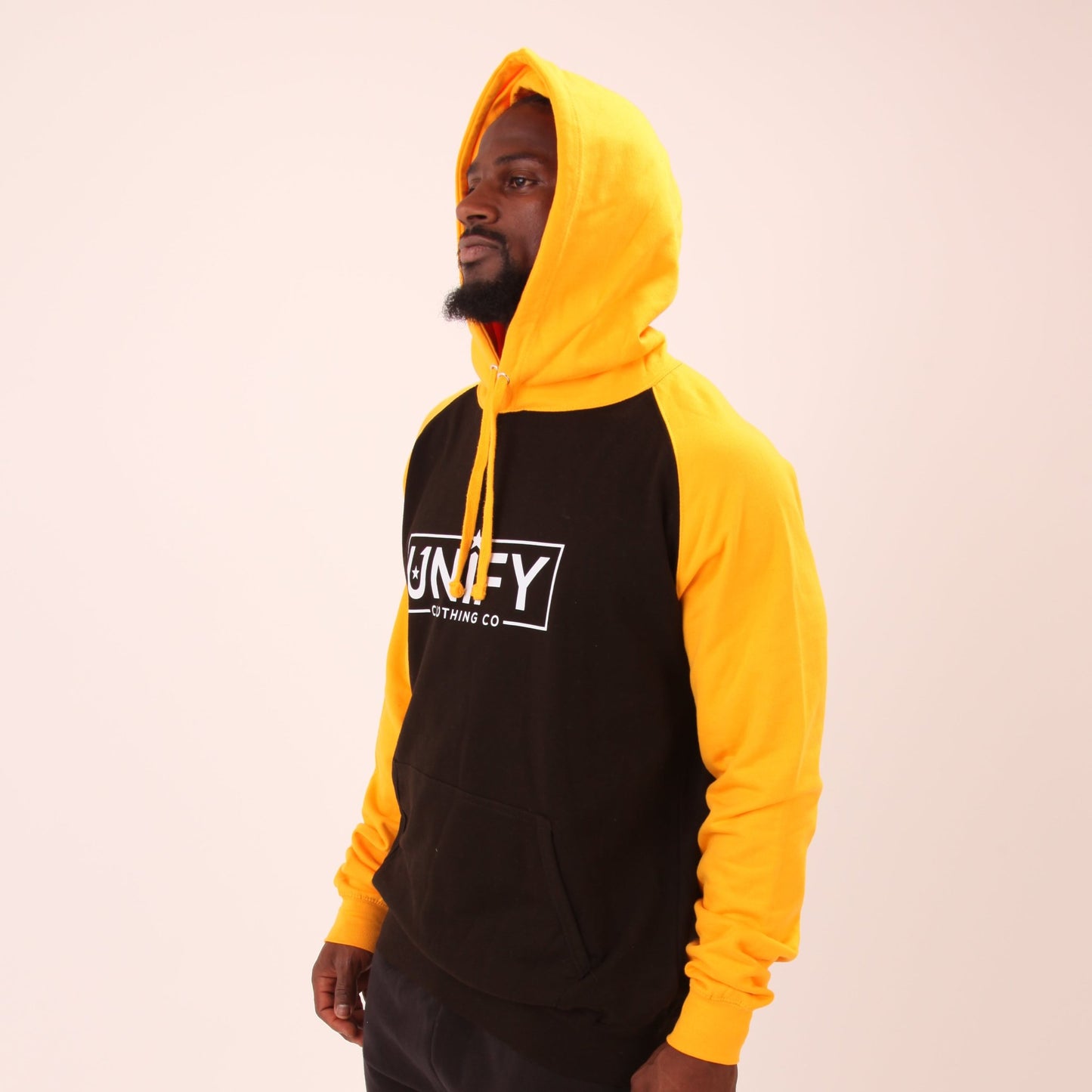 "Men's yellow jumper by UNIFY, designed for both comfort and bold style, showcased in a lifestyle setting."