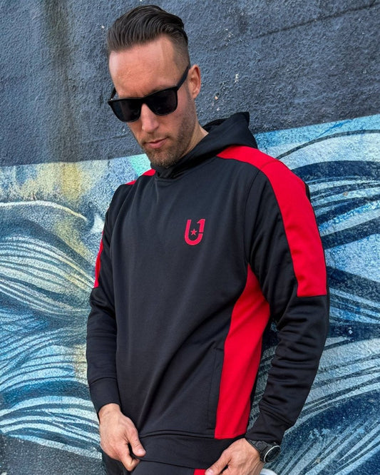 "Casual styling of UNIFY men's track pants with red stripes, paired with sneakers and a casual tee."