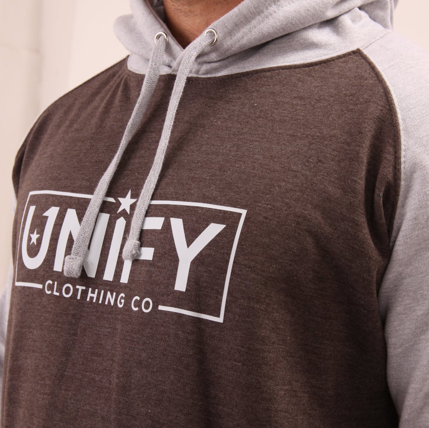 "Fashion-forward and functional, UNIFY's grey hoodie on a model, ideal for any urban adventure."
