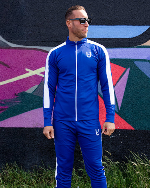 Full front view of UNIFY blue and white track suit with contrast stripe