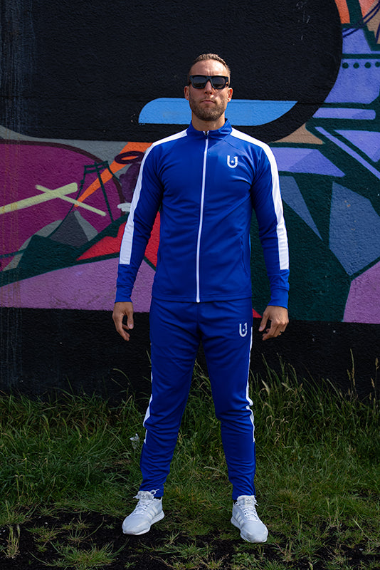 Model wearing UNIFY blue and white track suit styled for casual wear
