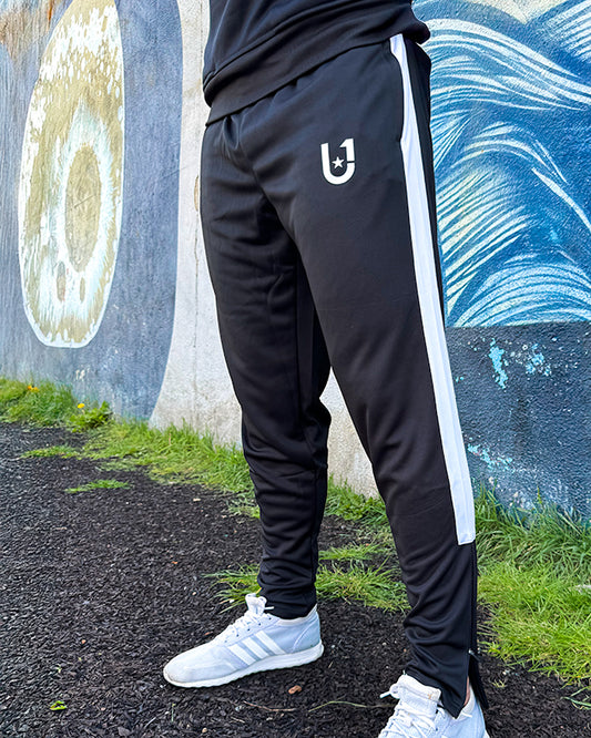 Front view of UNIFY men's black and white crossover track pants