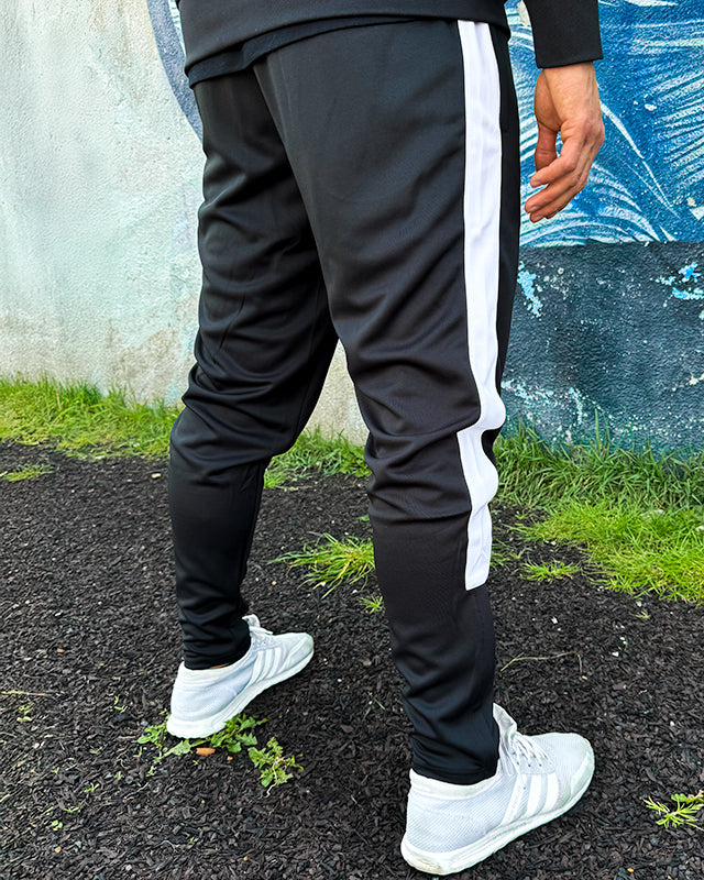 Model styled in UNIFY black and white men's track pants