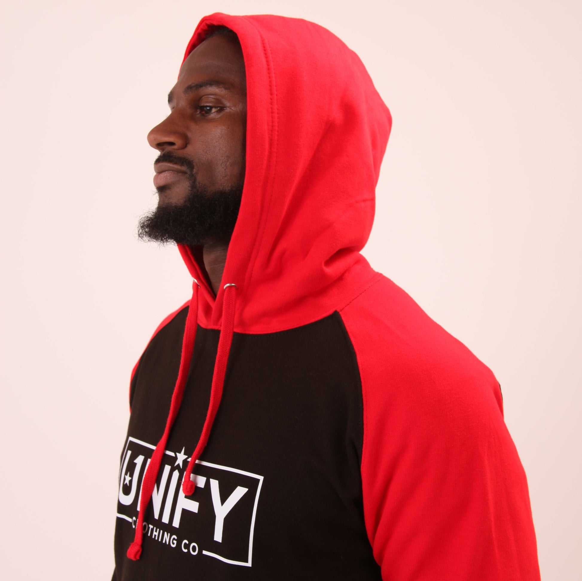 "Close-up of the UNIFY Red Jumper for Men, featuring quick-drying fabric and a deep hand warmer pocket."
