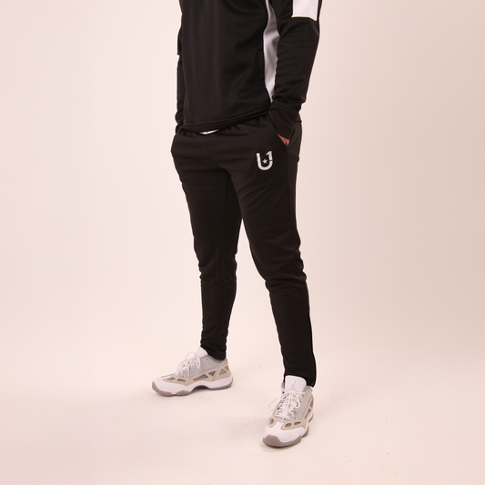 man wearing UNIFY men's black track pants designed for performance and everyday wear