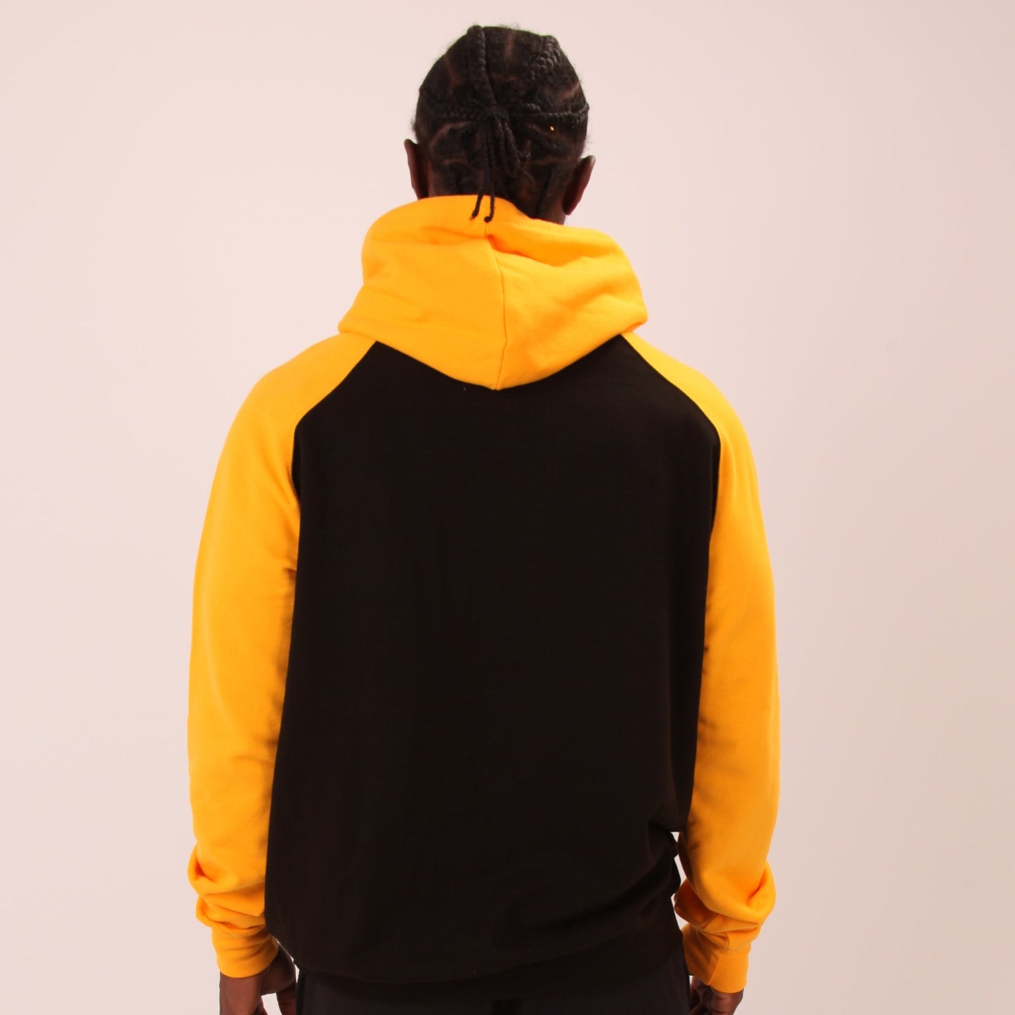 "Bright yellow hoodie from UNIFY worn by a male model, ideal for adding a pop of colour to your wardrobe."