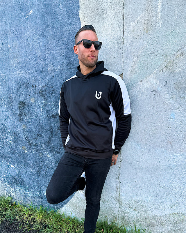 UNIFY men's tracksuit top in black with striking white stripes, perfect for a stylish athletic look.