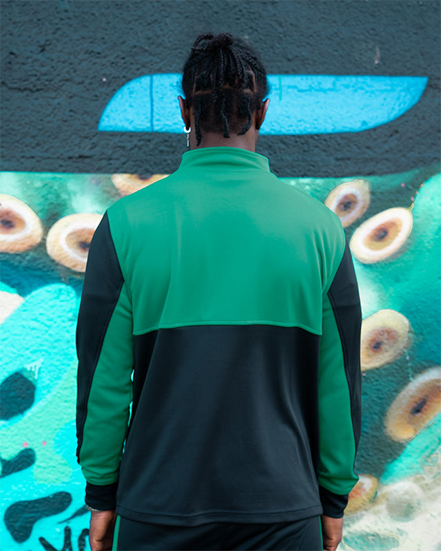 Styled outfit featuring UNIFY Motion Line green and black track top