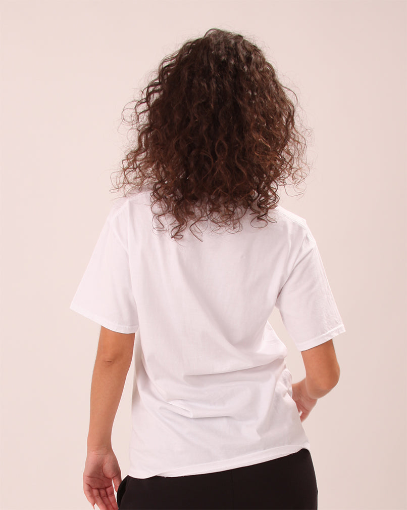 close-up of women’s UNIFY white t-shirt showing soft cotton fabric and minimal branding