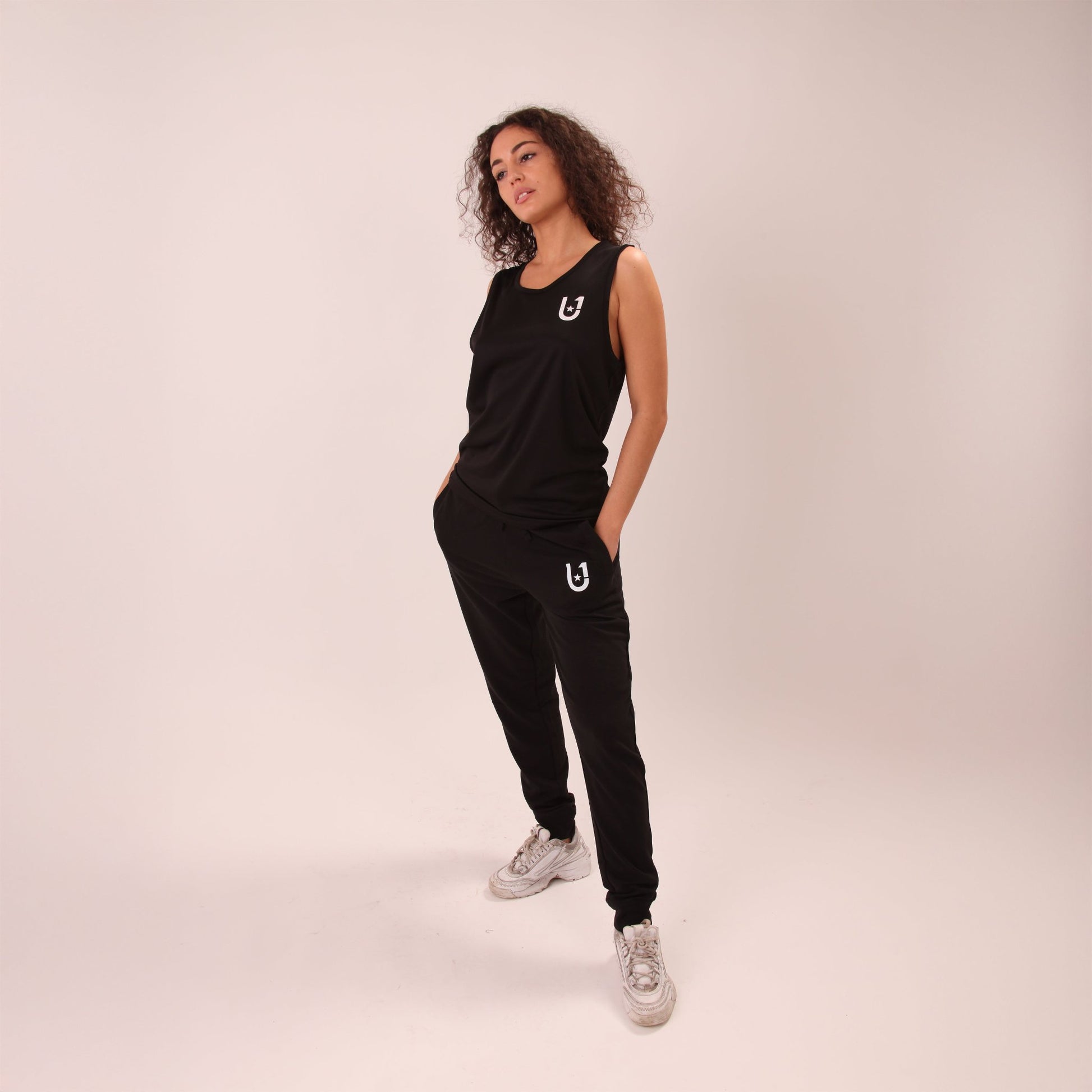 Woman lounging comfortably in UNIFY's casual joggers, ideal for a relaxed day.