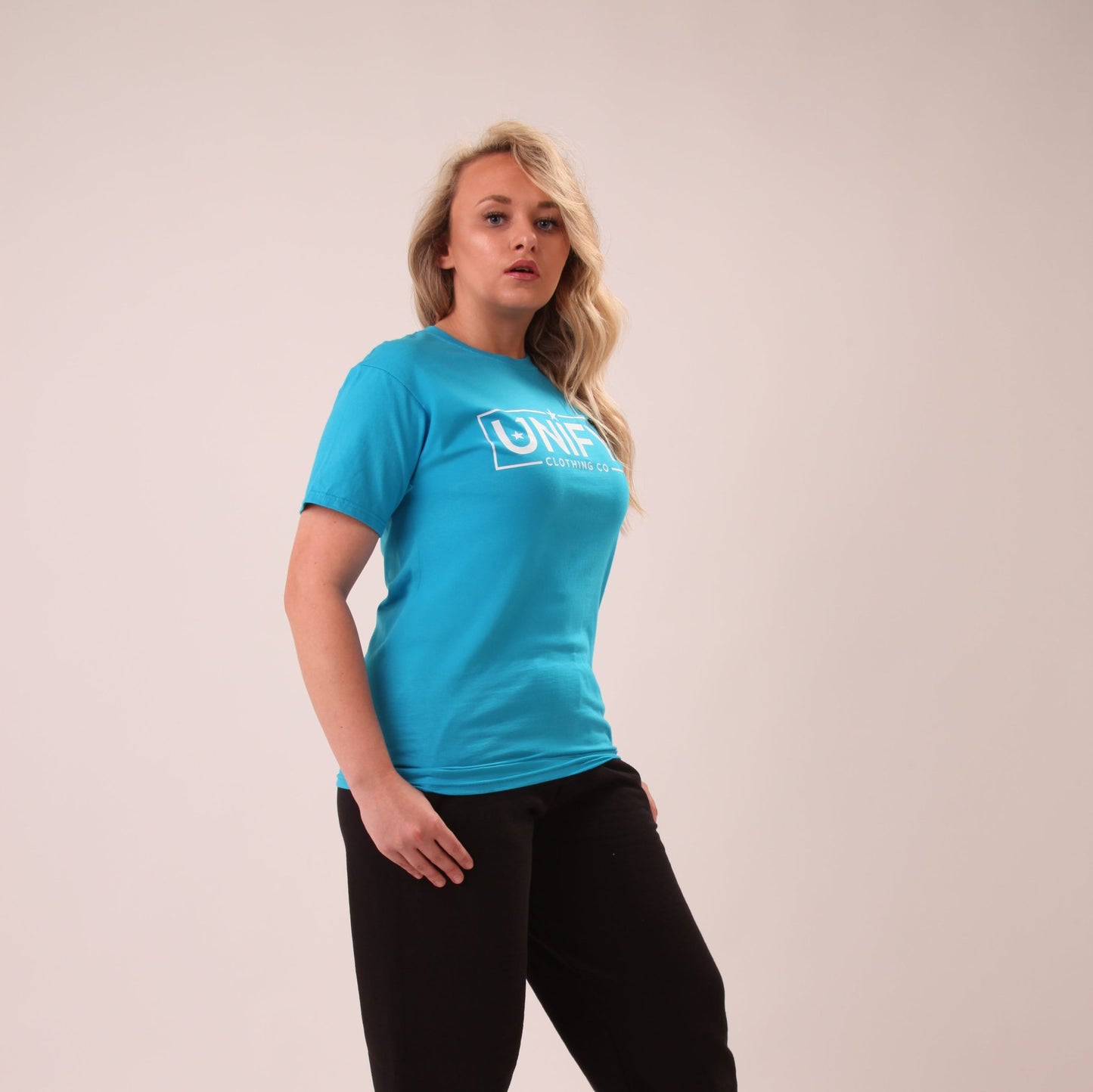 "Bright blue cotton tee worn by a woman, highlighting the vibrant colour and comfortable fit."
