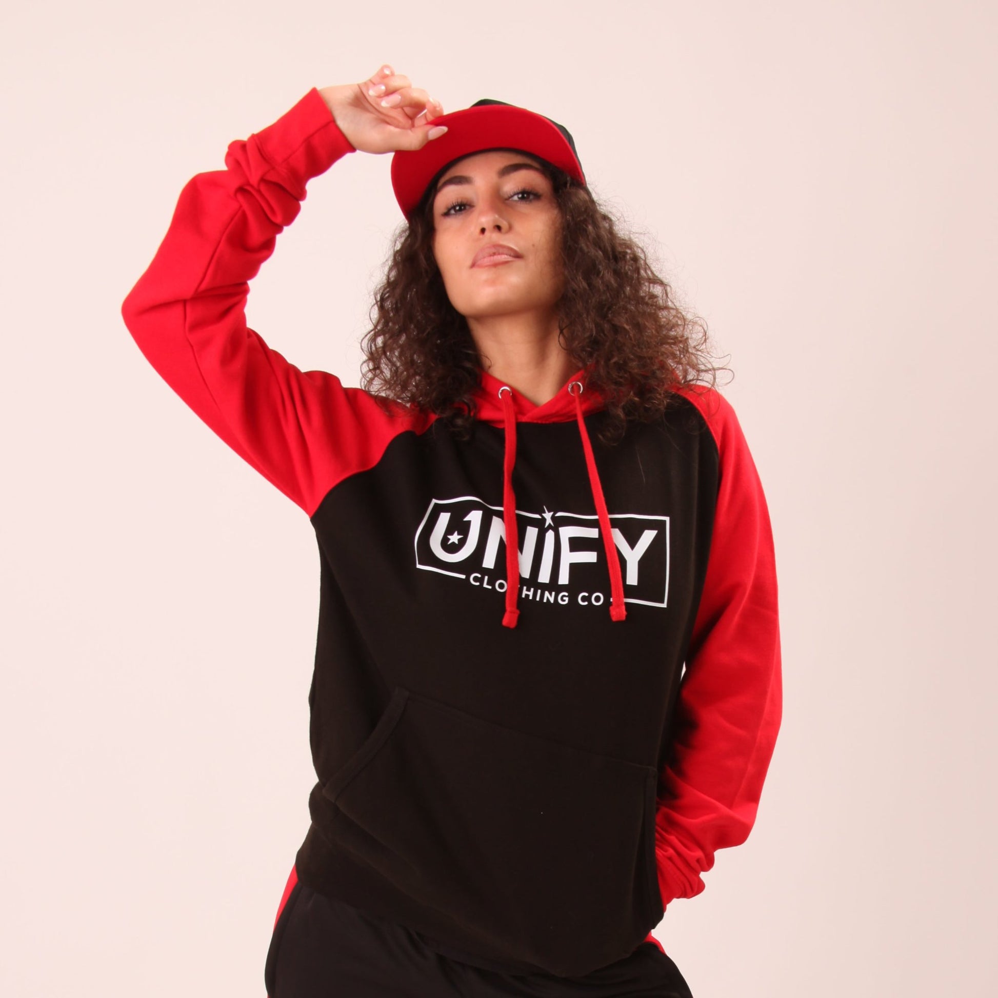 "Woman wearing UNIFY's essential hoodie, showcasing its versatile design suitable for both active and relaxed days."
