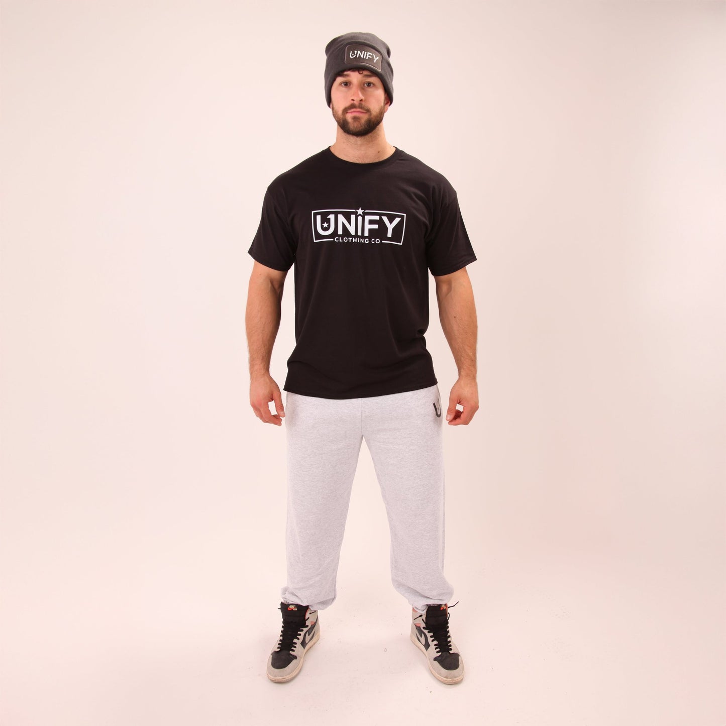 Close-up of UNIFY's men's grey relaxed joggers showing the soft fabric and comfortable design.
