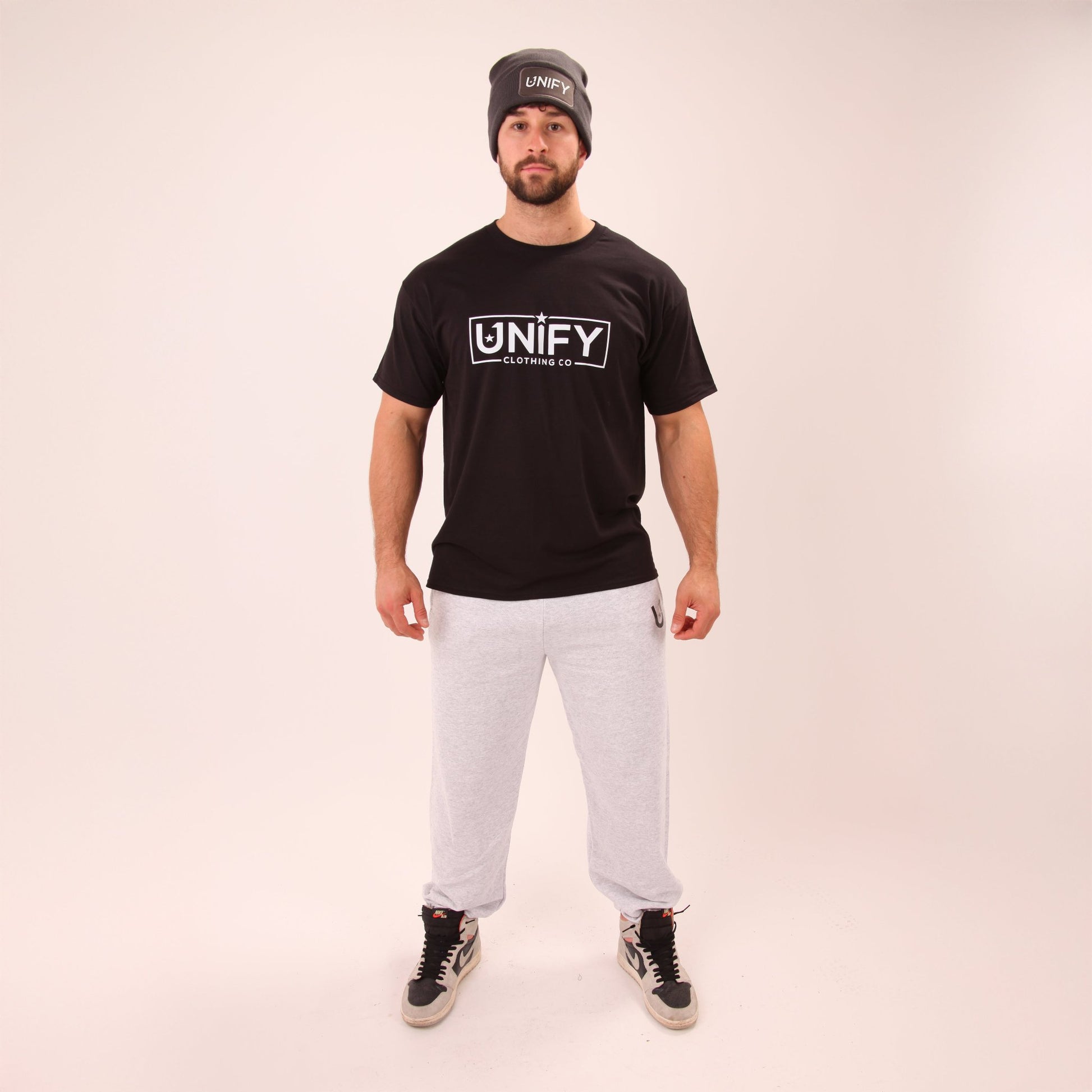 Close-up of UNIFY's men's grey relaxed joggers showing the soft fabric and comfortable design.
