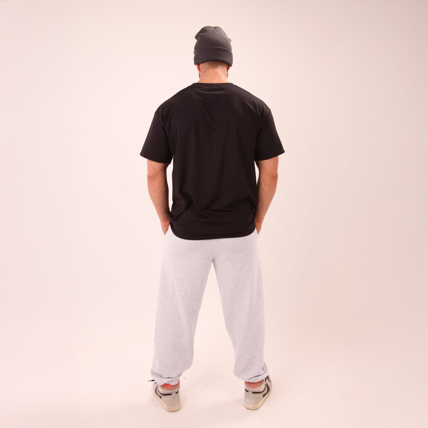 Man wearing UNIFY grey joggers, perfectly blending style and comfort for everyday wear.
