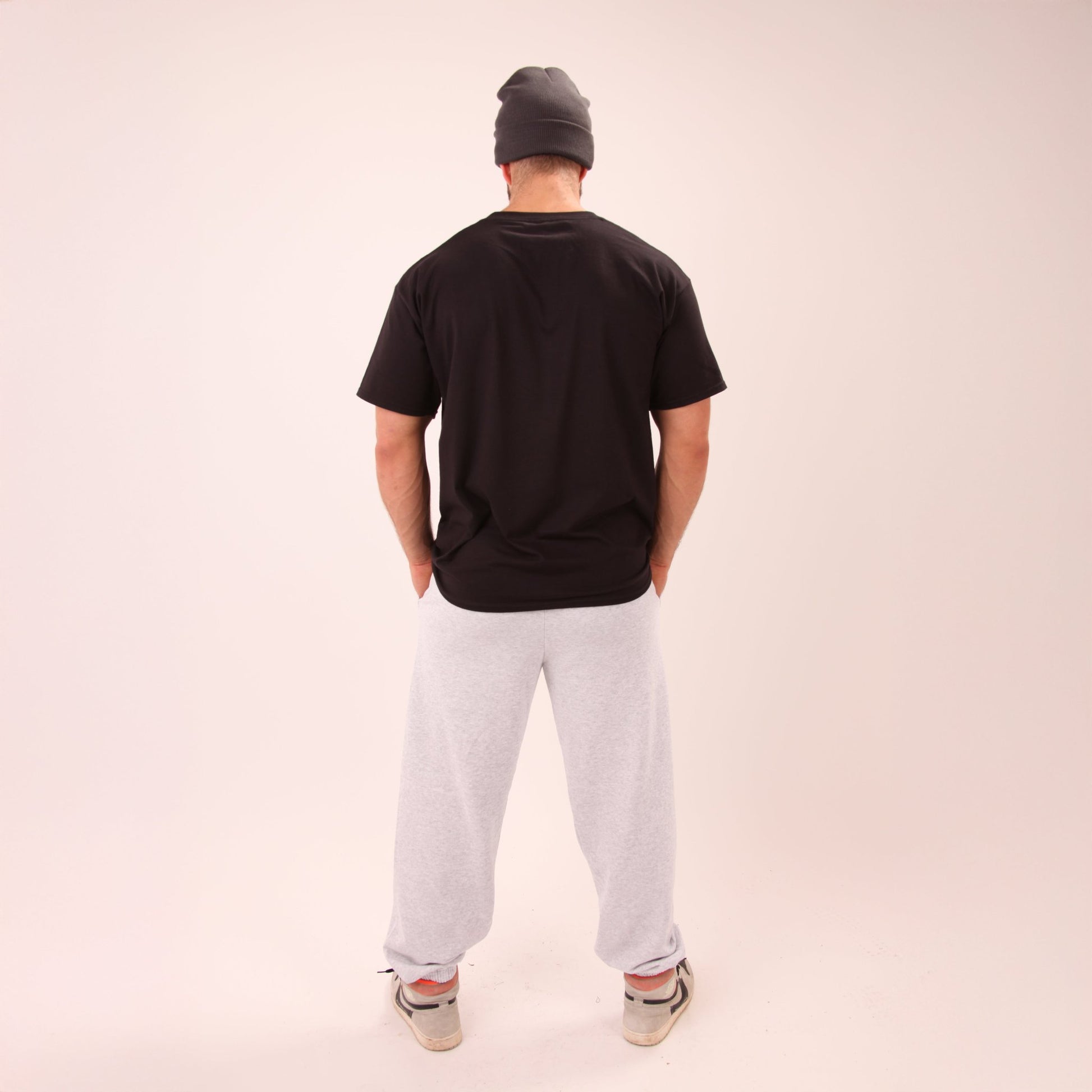 Man wearing UNIFY grey joggers, perfectly blending style and comfort for everyday wear.
