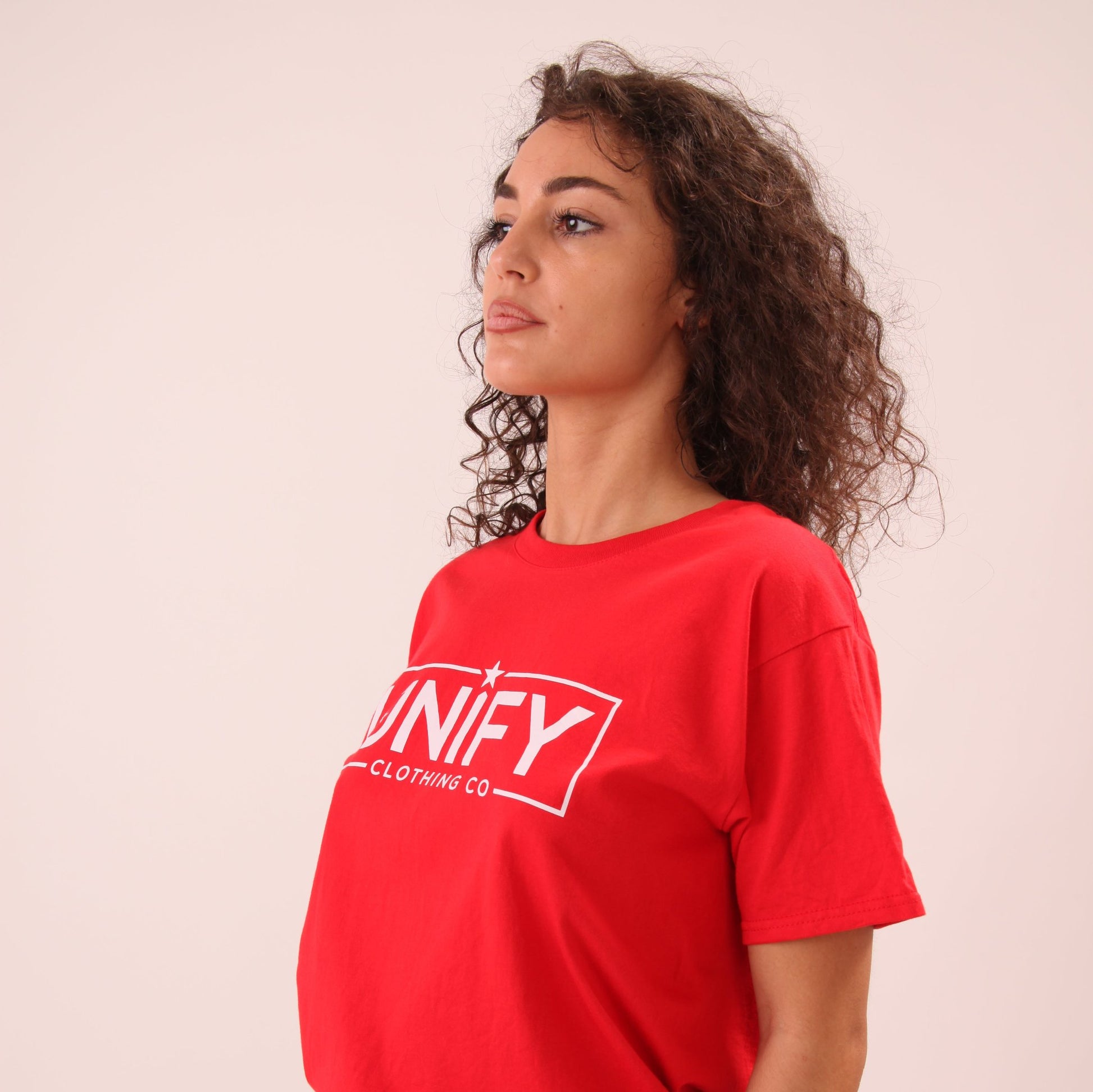"Casual chic women's fiery red tee, styled with denim for a relaxed and stylish look."
