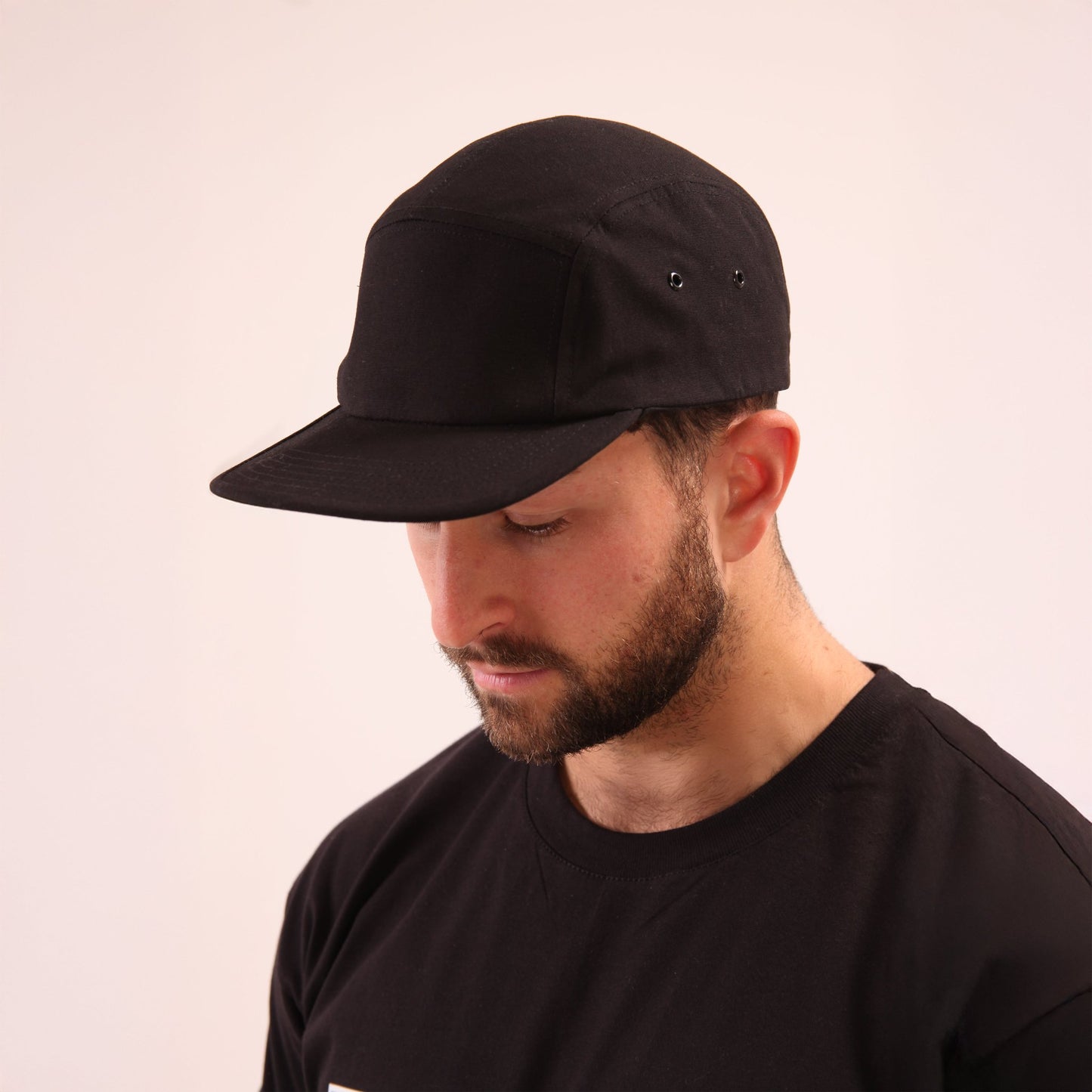 Close-up of UNIFY black streetwear cap, highlighting its sleek design and durable material.