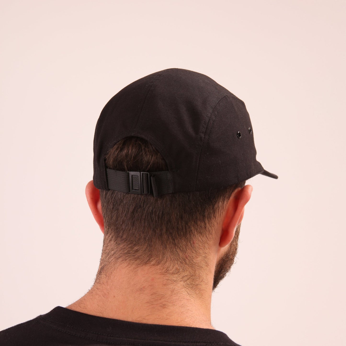 UNIFY's black streetwear cap displayed, featuring a minimalist design for maximum impact.