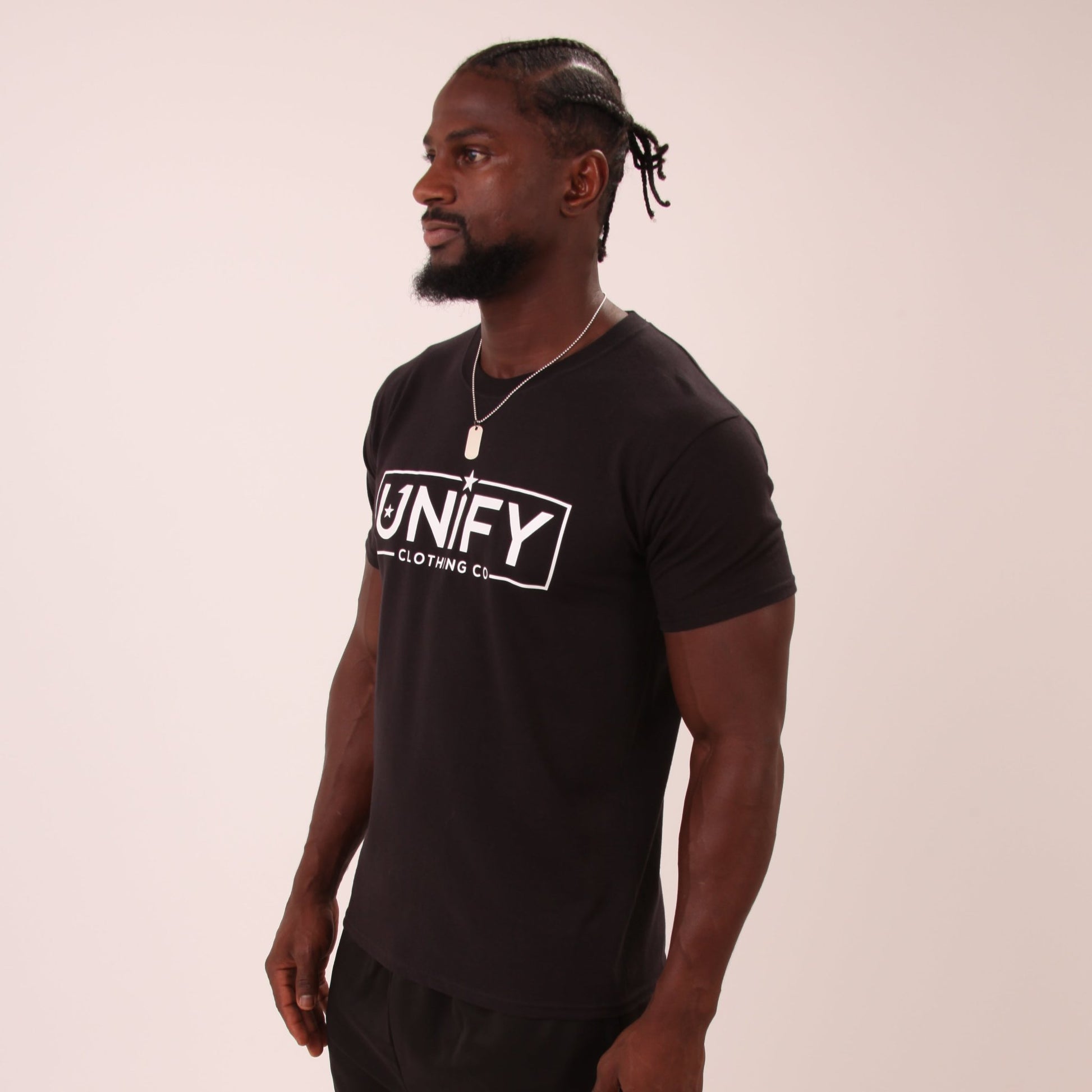 "Close-up of UNIFY Black T-Shirt fabric showing the fine texture and quality stitching."
