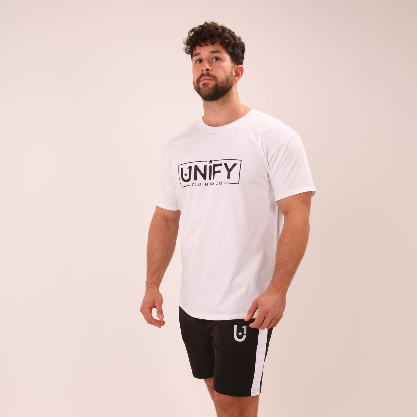 "Men's sleek white t-shirt, displayed on a hanger against a clean, neutral background."

