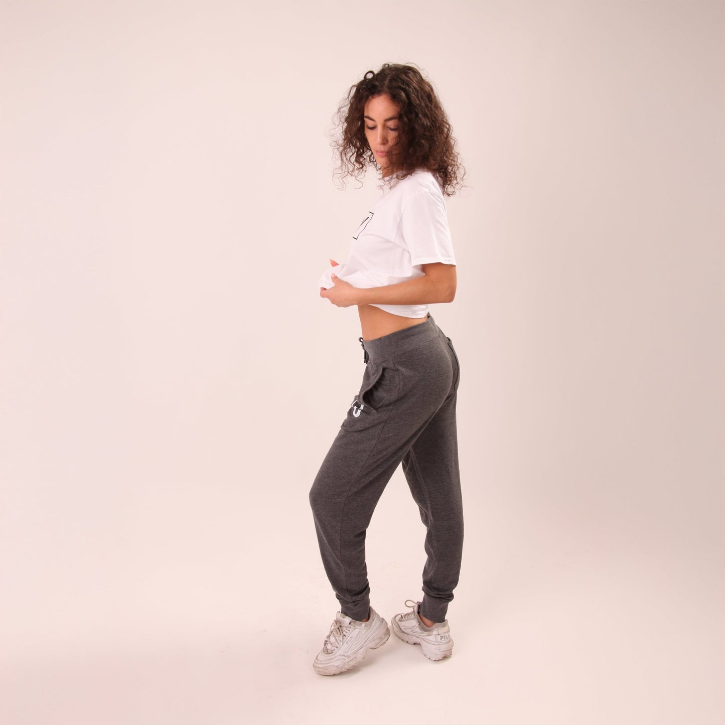 Detail view of UNIFY's women's grey joggers emphasizing the soft material and flattering fit.
