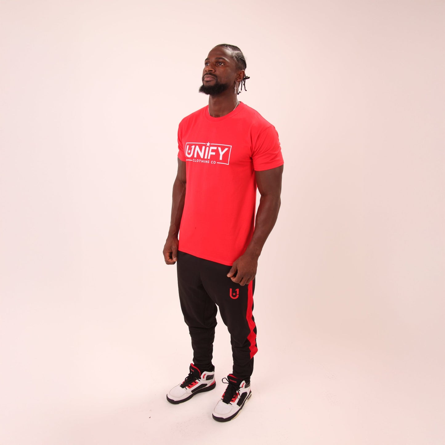Man wearing UNIFY's radiant red t-shirt, ideal for both casual wear and active lifestyles.