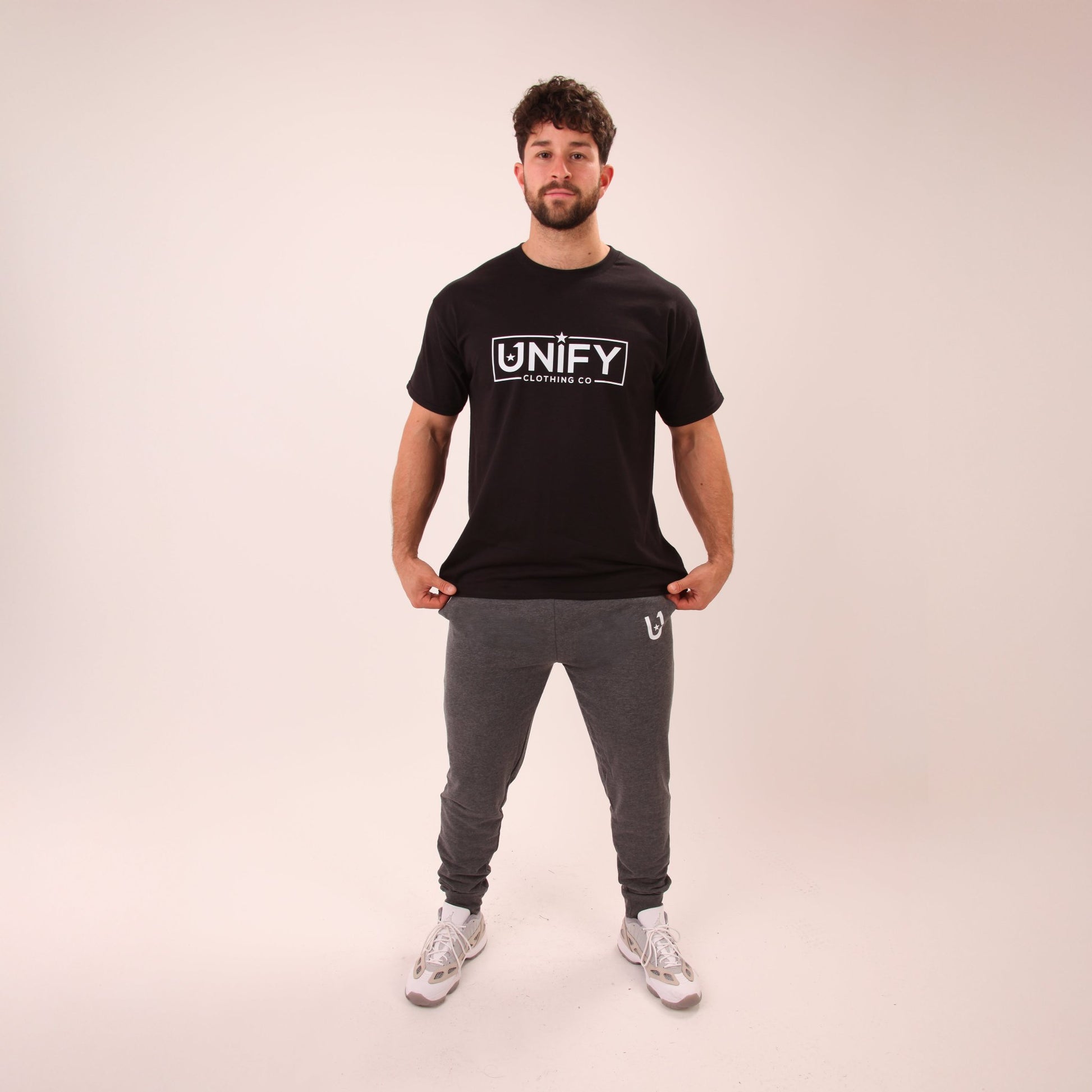 Detail of UNIFY's men's grey joggers showcasing their soft fabric and snug fit.
