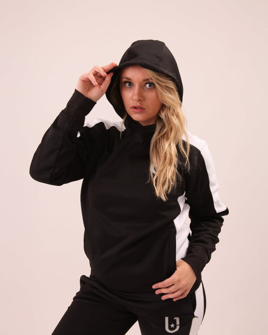 "Fashionable streetwear scene featuring a woman in UNIFY black and white track pants, perfect for urban style enthusiasts."
