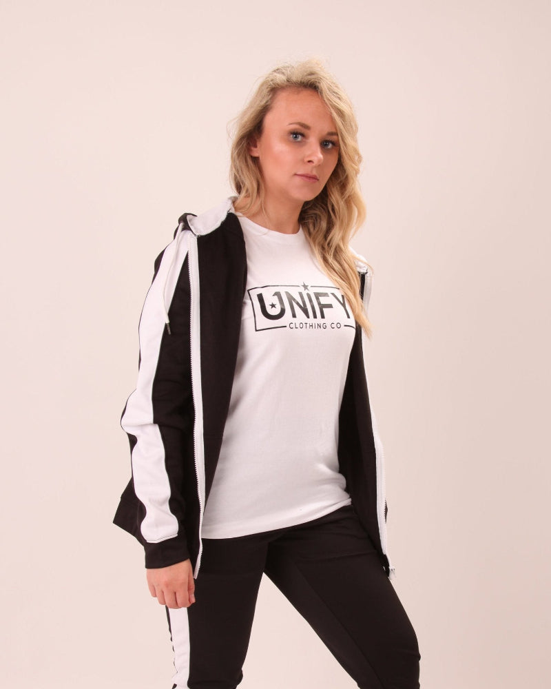 "Woman wearing UNIFY U1 black hoodie featuring a white stripe, ideal for a polished, sporty look."
