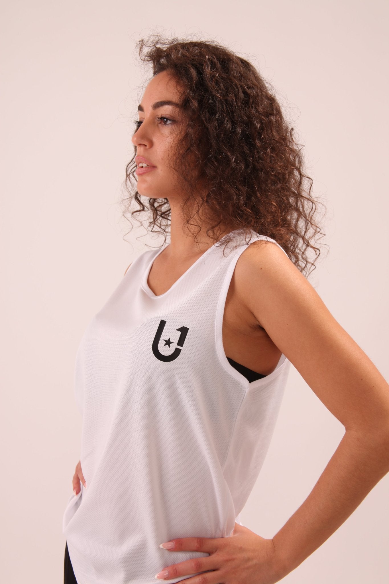 UNIFY Performance White Ladies Vest Top for women, designed for optimal breathability and style in active settings.