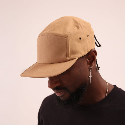 UNIFY's beige 5-panel cap, blending style with sophistication for an urban edge.