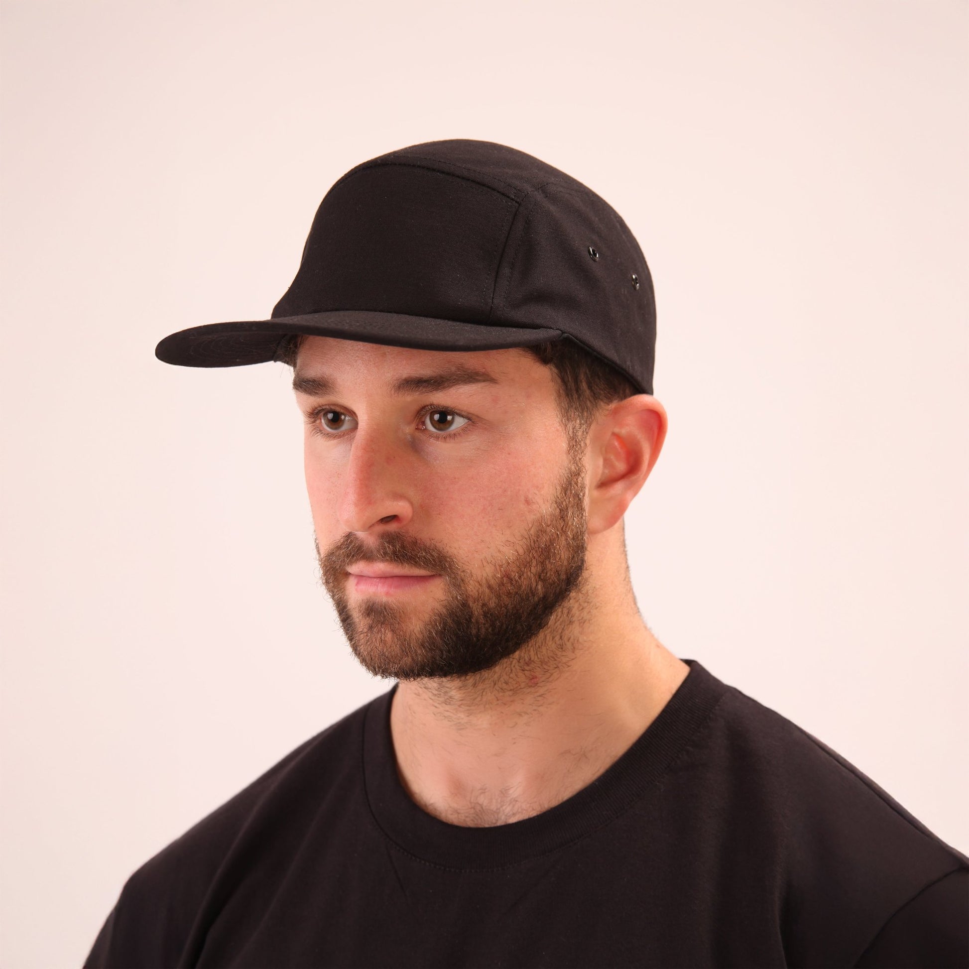 UNIFY's black 5-panel cap, perfect for a sophisticated urban look.
