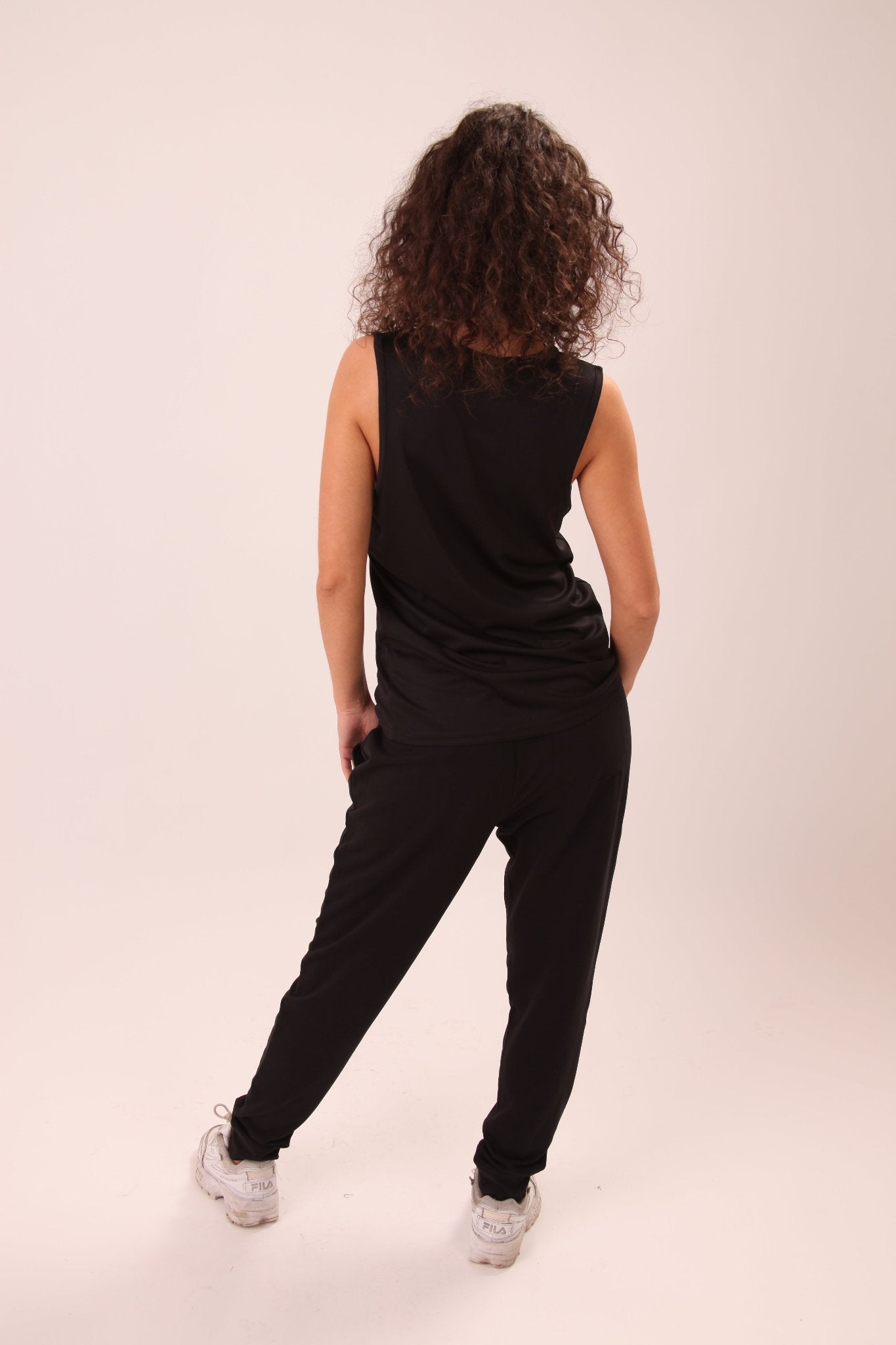 UNIFY women’s black performance vest top, crafted for durability and style, perfect for fitness enthusiasts.
