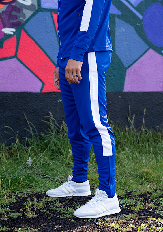 UNIFY blue track pants with white crossover detailing