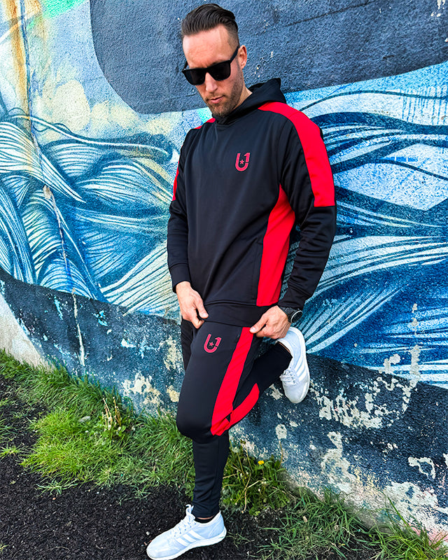 Model styled in UNIFY black and red stripe track suit for streetwear look