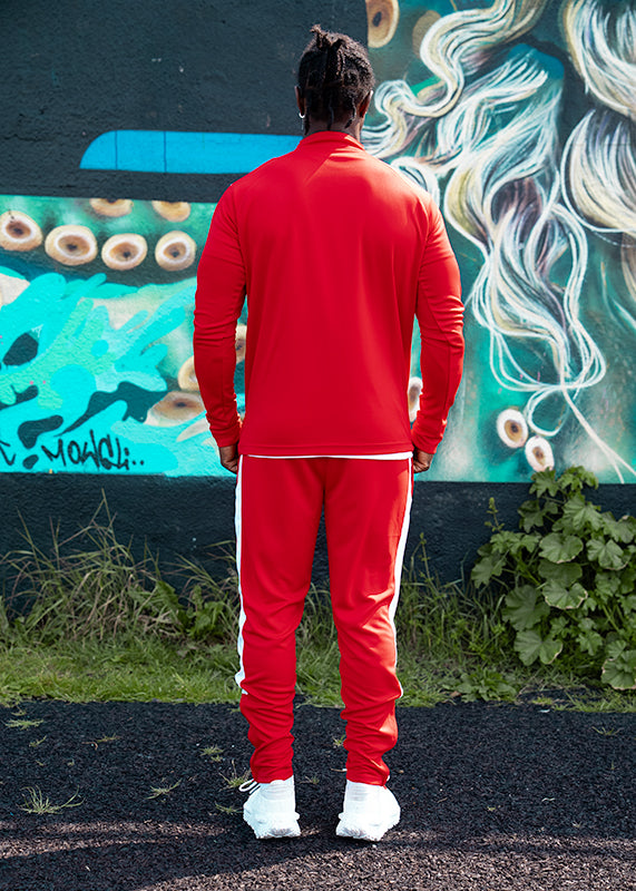 back profile of red and white track top from UNIFY showing athletic cut