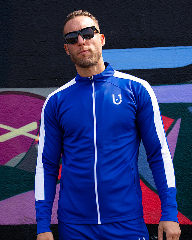Front view of the UNIFY blue and white track top showing full-length design