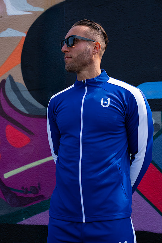 Model styled in UNIFY blue and white track top for a streetwear look