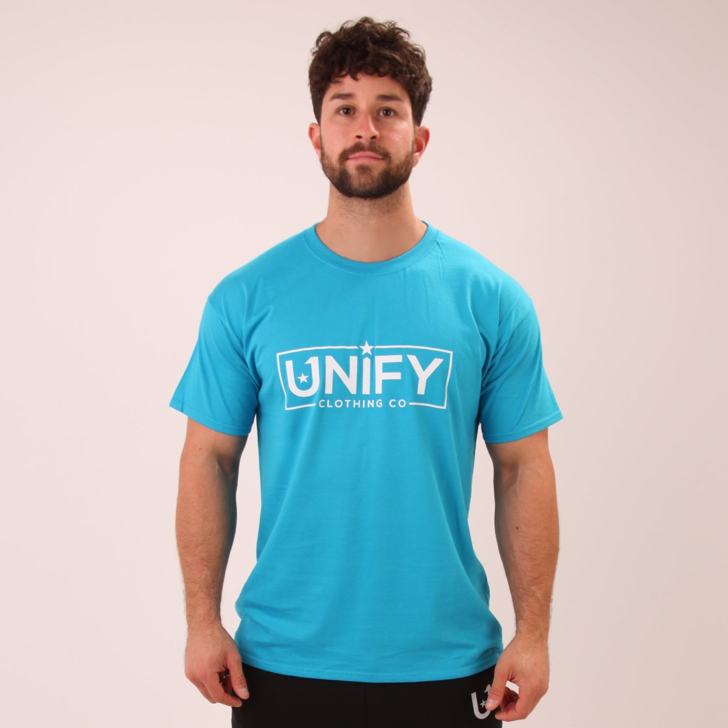 "UNIFY men's cool blue t-shirt, styled for a casual yet polished look."
