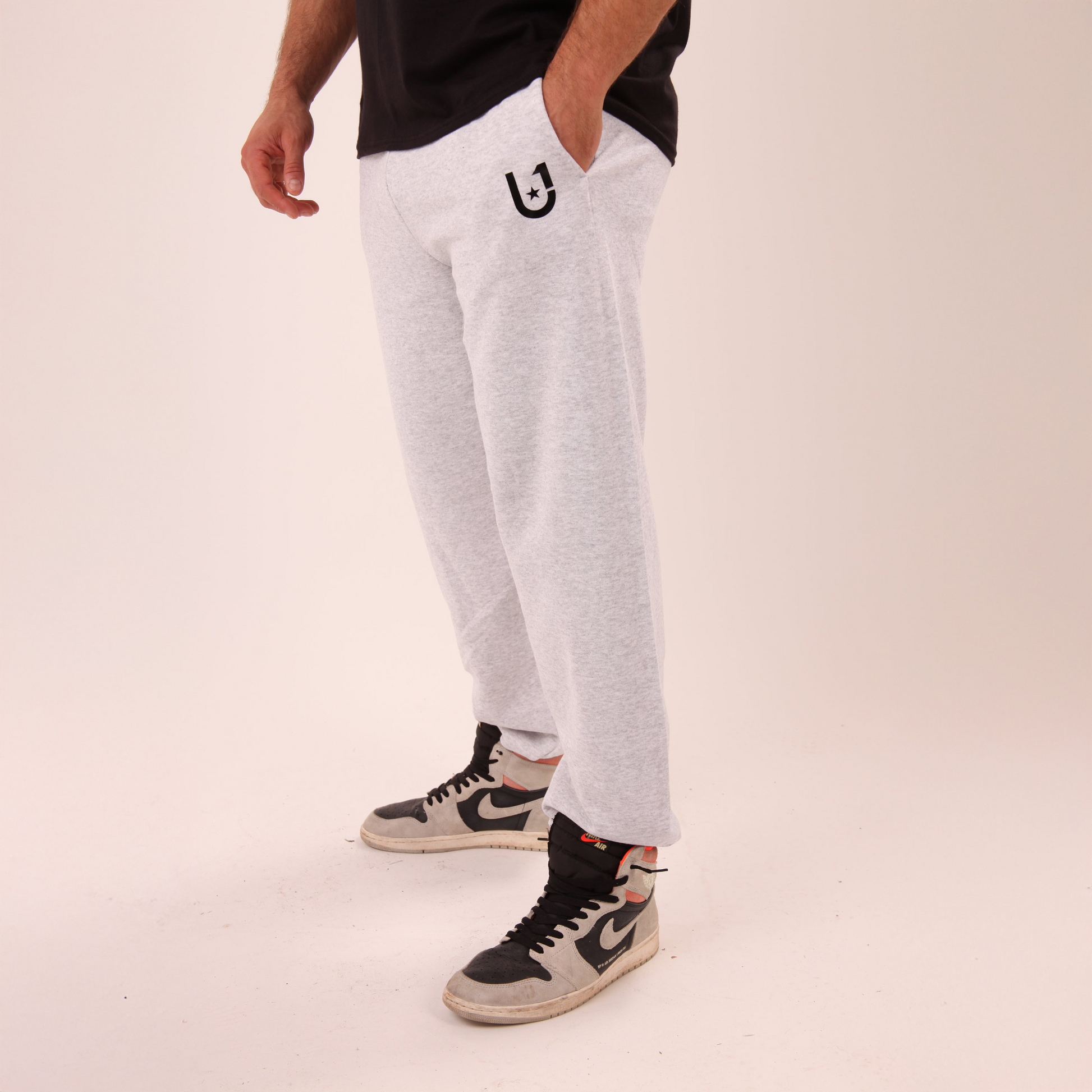 UNIFY men's grey joggers in relaxed fit, ideal for lounging or casual wear.
