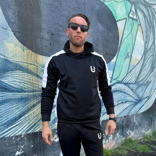 "UNIFY men's tracksuit top in black with striking white stripes, perfect for a stylish athletic look."

