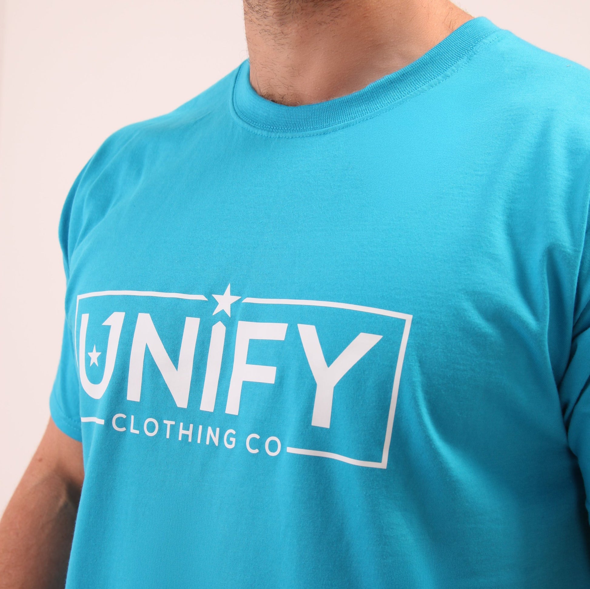 "UNIFY vibrant blue t-shirt on a male model, showcasing the rich color and comfortable fit."
