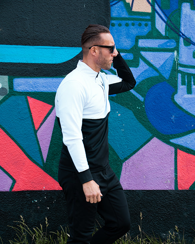 Close-up of collar design on white and black track top from UNIFY